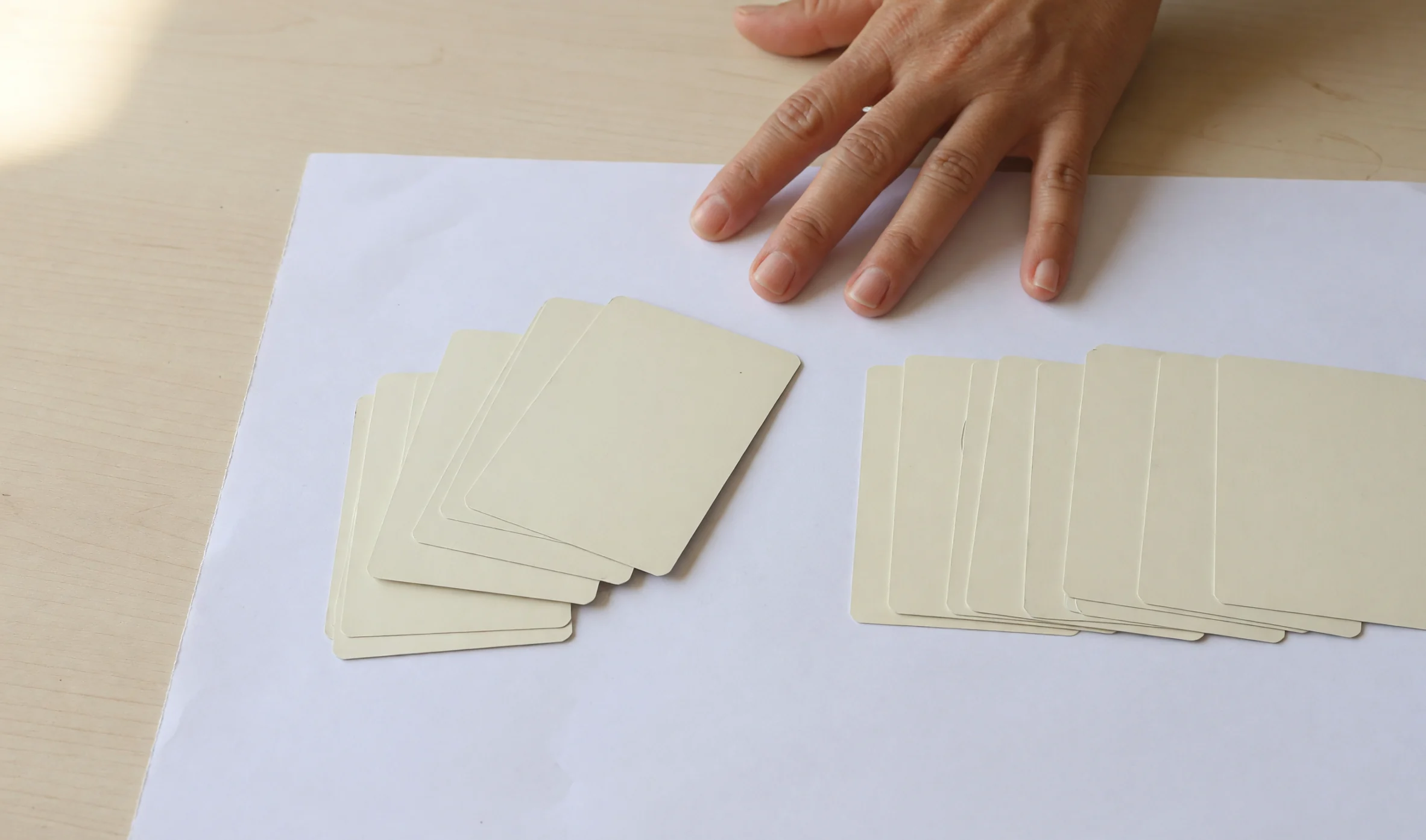 Two short card groups compared on white paper
